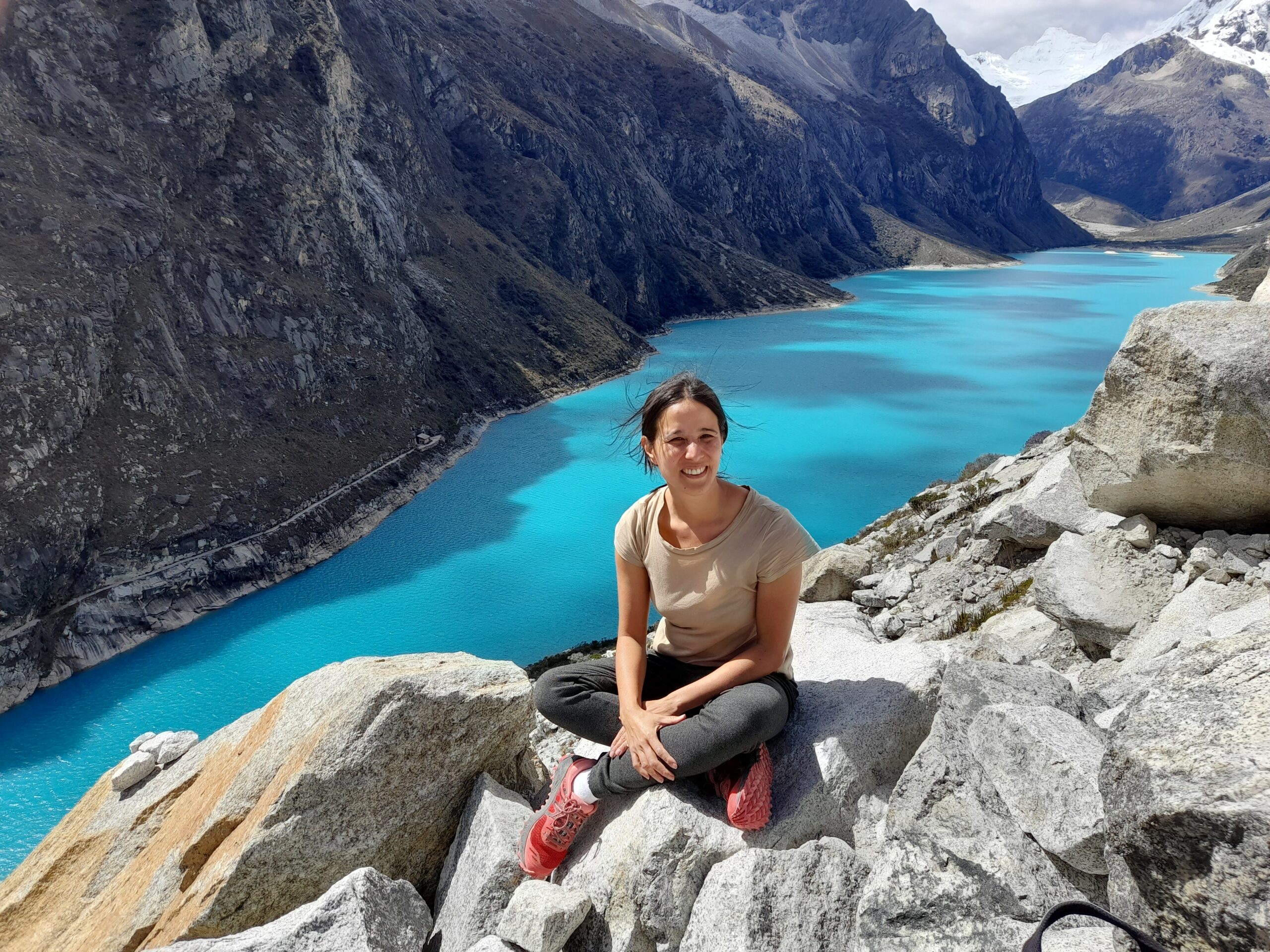 Me sitting at the viewpoint from where you can see the gorgeous turquoise laguna Paron, surrounded by mountains.