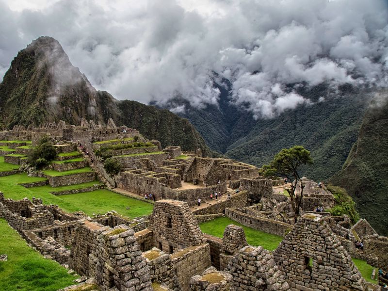 Machu Picchu covered by clouds during the rainy season in Peru