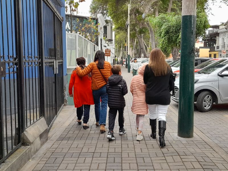People walking in the streets wearing winter clothes in Lima