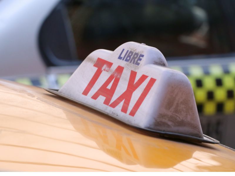 Taxi sign on a yellow taxi