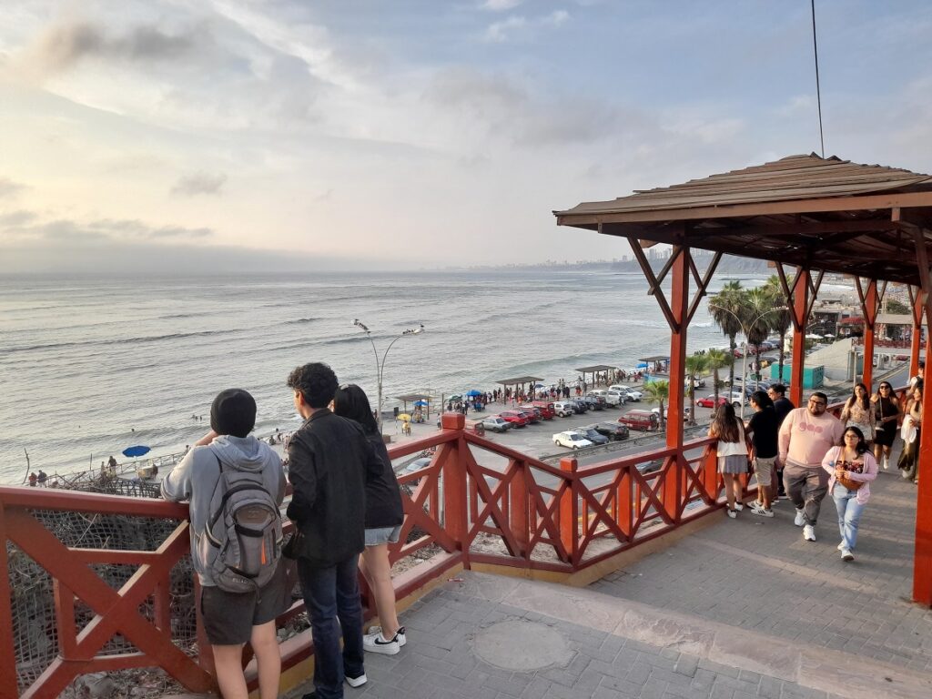 Crowded Bajada de Baños with people enjoying the outdoors in lighter clothes, a December scene emphasizing why it's a great time to visit Lima for holiday festivities and warm weather.