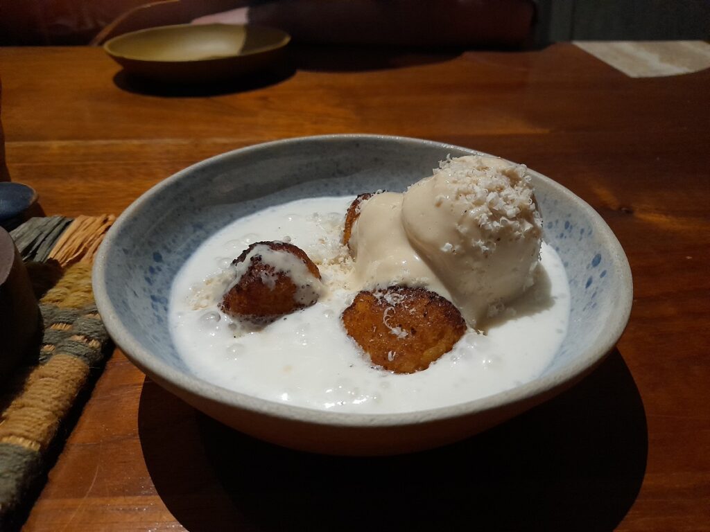 Dessert made of nuts with ice cream in a coconut sauce at Kjolle, a high-end restaurant in Peru.